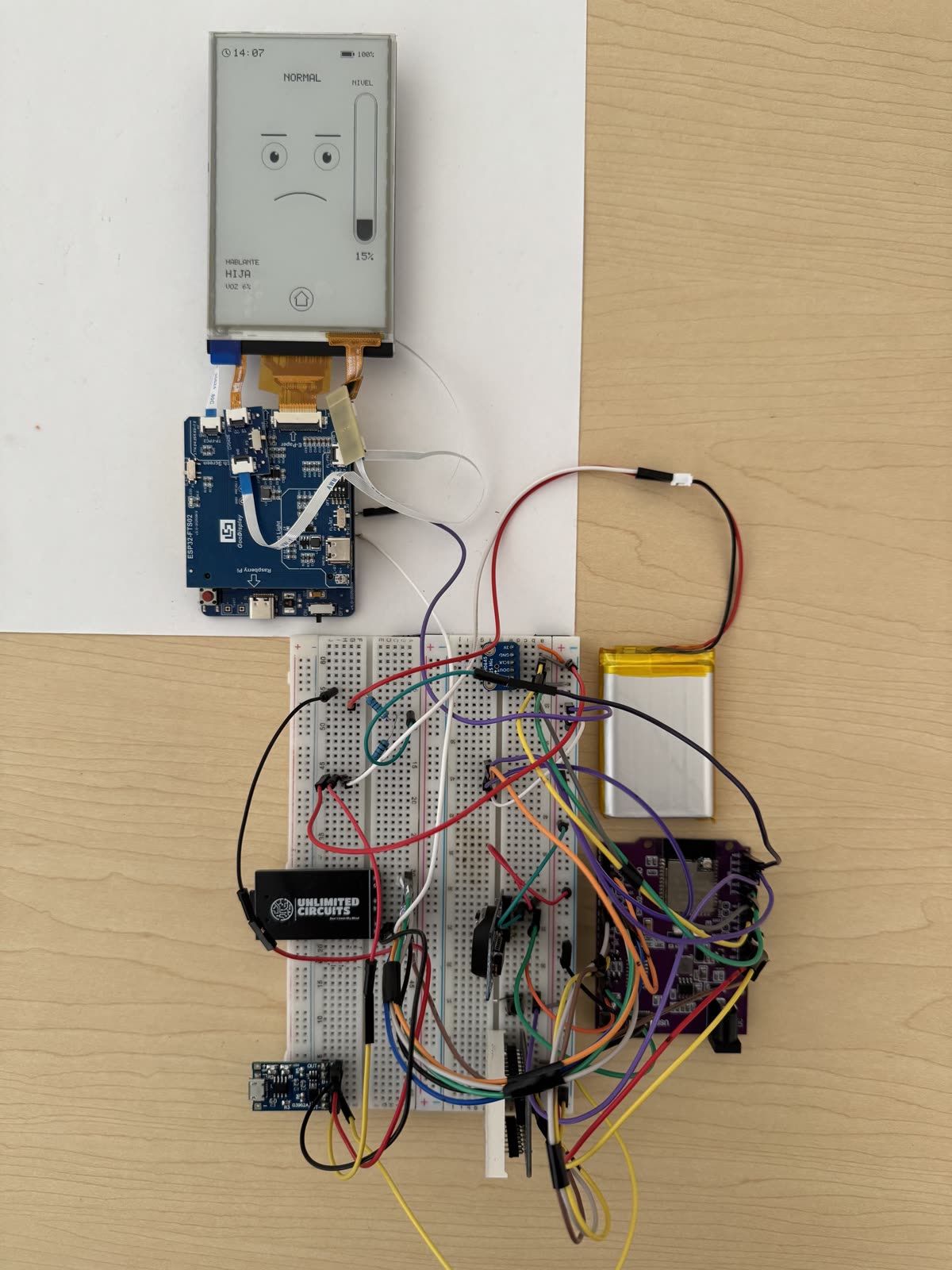 Breadboard prototype with ESP32-S3, MFCC pipeline, and an e-paper display showing real-time emotion classification